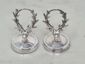 A pair of George V silver Menu Holders in the form stag's heads on circular bases, Birmingham 1912