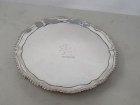 A George III silver circular Waiter engraved crest, gadroon rim on three hoof feet, London 1773,