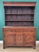 An early 19th century oak Dresser and Rack, the enclosed base fitted two short drawers above pair of