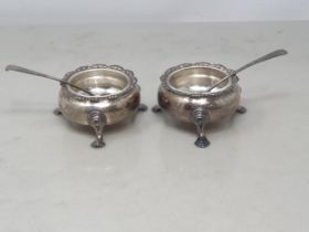 A pair of George II silver Cauldron Salts with shaped rims on hoof feet, engraved initials E * B,