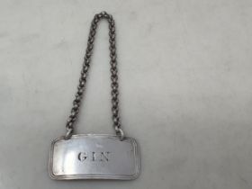 A Victorian silver Gin Label, Birmingham 1848, maker: George Unite, a Bangle and a silver