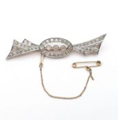 An Art Deco Diamond Brooch, three rubover-set old-cut diamonds in an oval frame of similarly set