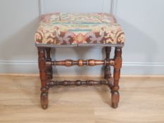 An 18th century walnut Stool with woolwork upholstered seat depicting birds amongst flowering