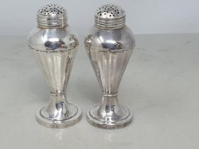 A pair of George III silver Pepperettes of inverted baluster form on circular bases, London 1794,