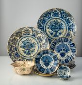 A MIXED LOT OF TWELFE FAIENCE PLATES DISHES AND BOWLS