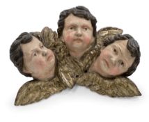 A GROUP OF THREE PUTTO HEADS