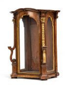 A BAROQUE CARVED AND PARCEL GILT WALNUT DISPLAY CASE