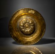 A LARGE SOUTH GERMAN EMBOSSED BRASS DISH
