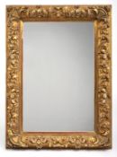 A DECORATIVE GILT FRAME WITH MIRROR GLASS