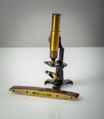 A MICROSCOPE IN A WOODEN BOX WITH ACCESSORIES