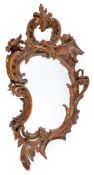 A CARTOUCHE SHAPED CARVED AND BROWN GLAZED MIRROR