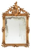 A BAROQUE STYLE CARVED WOOD, STUCCO SILVERED AND GILT DECORATIVE MIRROR