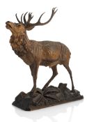 A CARVED WOOD MODEL OF A DEER