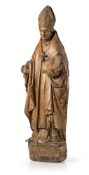 A LARGE LATE MEDIEVAL CARVED WALNUT FIGURE OF ST. NICHOLAS