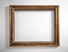 A carved, painted and silvered reverse profile frame