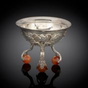 A FLORAL STYLED SILVER SALT CELLAR ON AGATE FEET