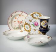 FOUR PLATES AND A VASE