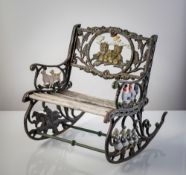 A CAST IRON KIDS' ROCKING CHAIR