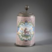 A GERMAN MANGANESE COLOURED FAIENCE TANKARD WITH ANIMAL