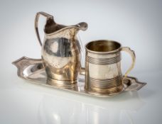 A SMALL TRAY, A BEAKER AND A MILK POT