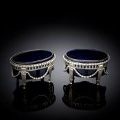 A PAIR OF GERMAN OPENWORK SILVER SALT CELLARS WITH BLUE GLASS LINERS
