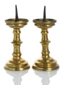 A PAIR OF BAROQUE BRONZE OR BRASS CANDLESTICKS