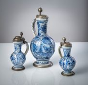THREE PEWTER MOUNTED BLUE AND WHITE PAINTED FAIENCE JARS