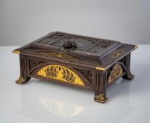 AN ART NOUVEAU GILT BRASS MOUNTED CARVED AND STAINED WOOD CASE