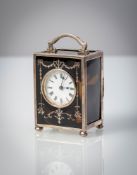 A SMALL ENGLISH SILVER MOUMTED TORTOISE SHELL TRAVELLERS CLOCK