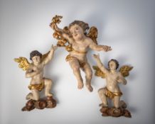 A PAIR OF WINGED ANGELS ON A BAND OF CLOUDS AND A FLYING ANGEL WITH GARLAND