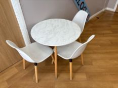 White Wooden Table With Three Plastic Chairs