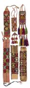 SIX LAKAI EMBROIDERED BANDS AND AN AMULET, UZBEKISTAN, LATE 19TH/EARLY 20TH CENTURY