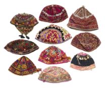 A COLLECTION OF TEN EMBROIDERED AND EMBELLISHED HATS, CENTRAL ASIA AND AFGHANISTAN, 20TH CENTURY