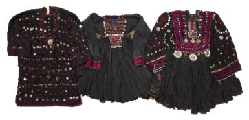 THREE EMBROIDERED AND DECORATED WEDDING DRESSES (JUMLOS), AFGHANISTAN/NORTHWEST PAKISTAN, 1960-1980