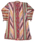 A QUILTED IKAT BOY'S CHAPAN, BOKHARA, UZBEKISTAN, CIRCA 1900
