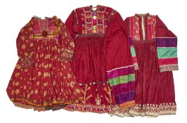 A KUTCHI DRESS AND TWO SIMILAR DRESSES, AFGHANISTAN, 20TH CENTURY