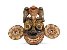 A CARVED AND PAINTED WOOD RITUAL MASK, SRI LANKA, 19TH CENTURY