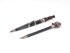 A LETTER OPENER IN THE FORM OF A SCOTTISH BASKET-HILTED BROADSWORD, AND A MINIATURE DIRK OF THE