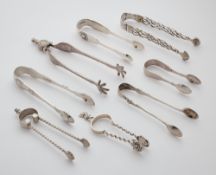 A GROUP OF EIGHT ENGLISH SILVER SUGAR TONGS