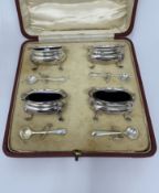 A CASED SET OF FOUR GEORGE V SILVER SALT CELLARS AND FOUR SPOONS, MAPPIN & WEBB LTD., BIRMINGHAM, 19