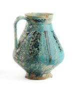 A TURQUOISE GLAZED JUG, KASHAN OR GURGAN, CIRCA 12TH CENTURY