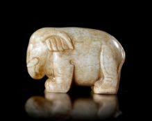 A PALE CELADON JADE ELEPHANT, CHINA, HAN DYNASTY (206 BC–220 AD)