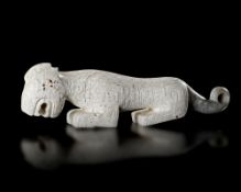 A CHINESE WHITE JADE TIGER, SHANG DYNASTY (CIRCA 1600–1046 BC)