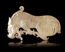A YELLOW JADE TIGER PLAQUE, CHINA, ZHOU - EARLY HAN PERIOD (1046-150 BC)