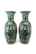 A pair of Chinese Famille verte decorated on a turquoise background porcelain vases