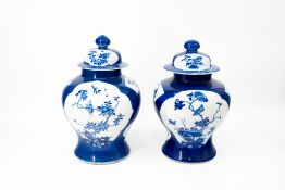 A lot of two matching Chinese blue and white bird and flora decorated covered porcelain vases