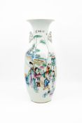 A Chinese Qianjiang and Famille rose decorated porcelain vase with a figural scene of ladies and the