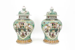 A pair of Chinese Famille verte decorated porcelain vases with figural palace scenes