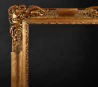 20th Century European School. A Gilt and Painted Composition Frame, with swept and pierced centres