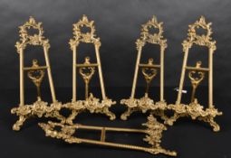 20th Century English School. A Set of Five Brass Picture Stands, height 16.25
